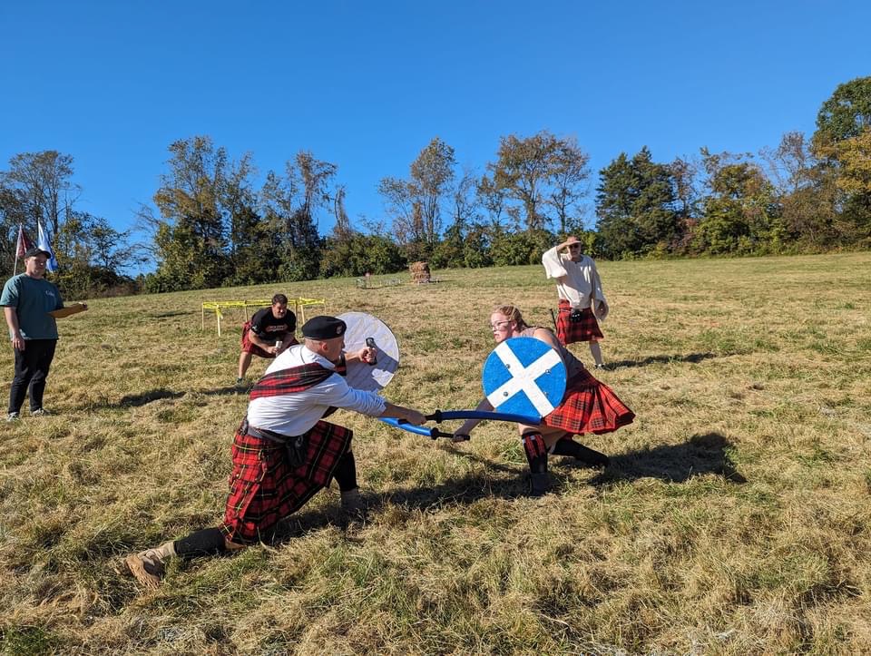 Highland Games athletes and spectators gathered outdoors
