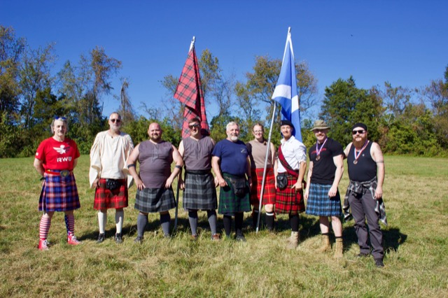 Highland Games participants lined up with flags